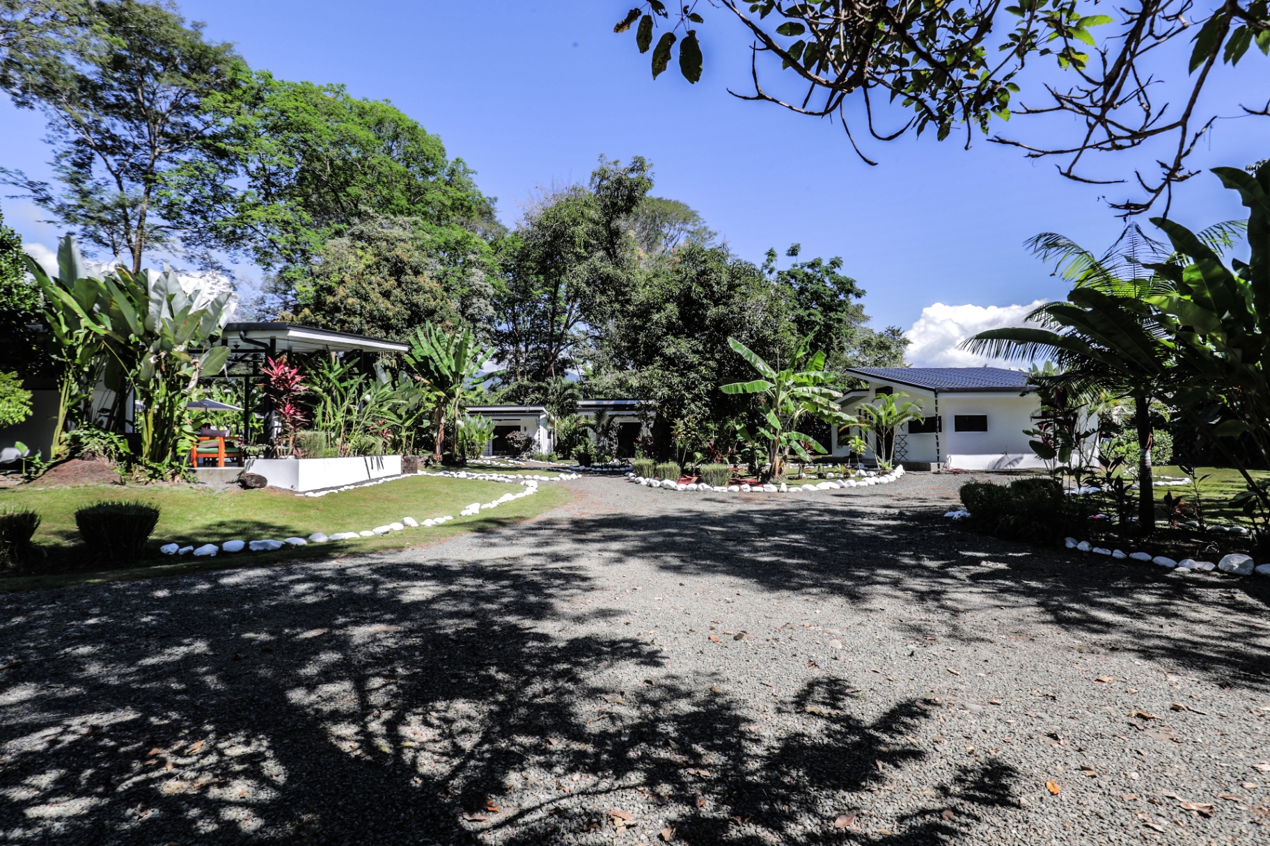 Landscaped grounds of The Retreat Uvita with stone-lined pathways, palms and casitas nestled among tropical trees