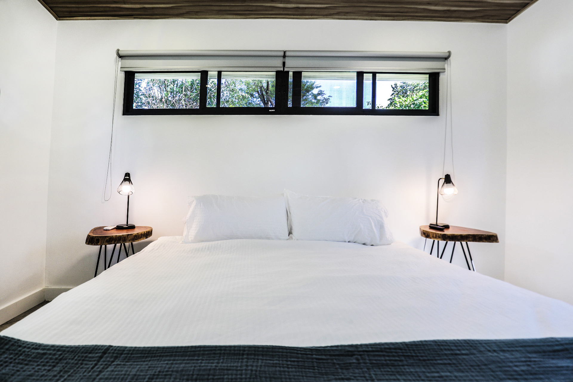 King bedroom with air conditioning, wood ceiling and live-edge nightstands in Unit 2 at The Retreat Uvita