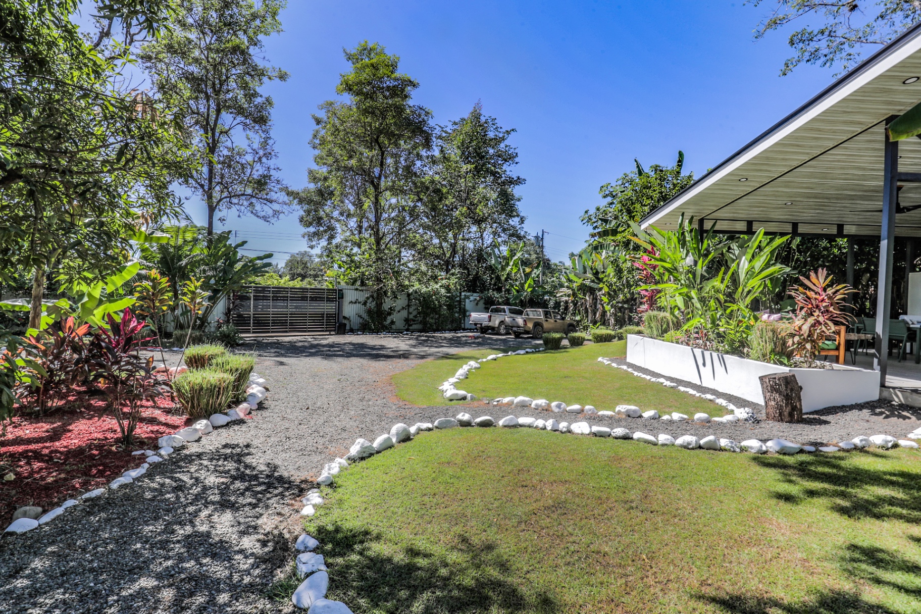 Landscaped gardens and gravel pathways between the casitas